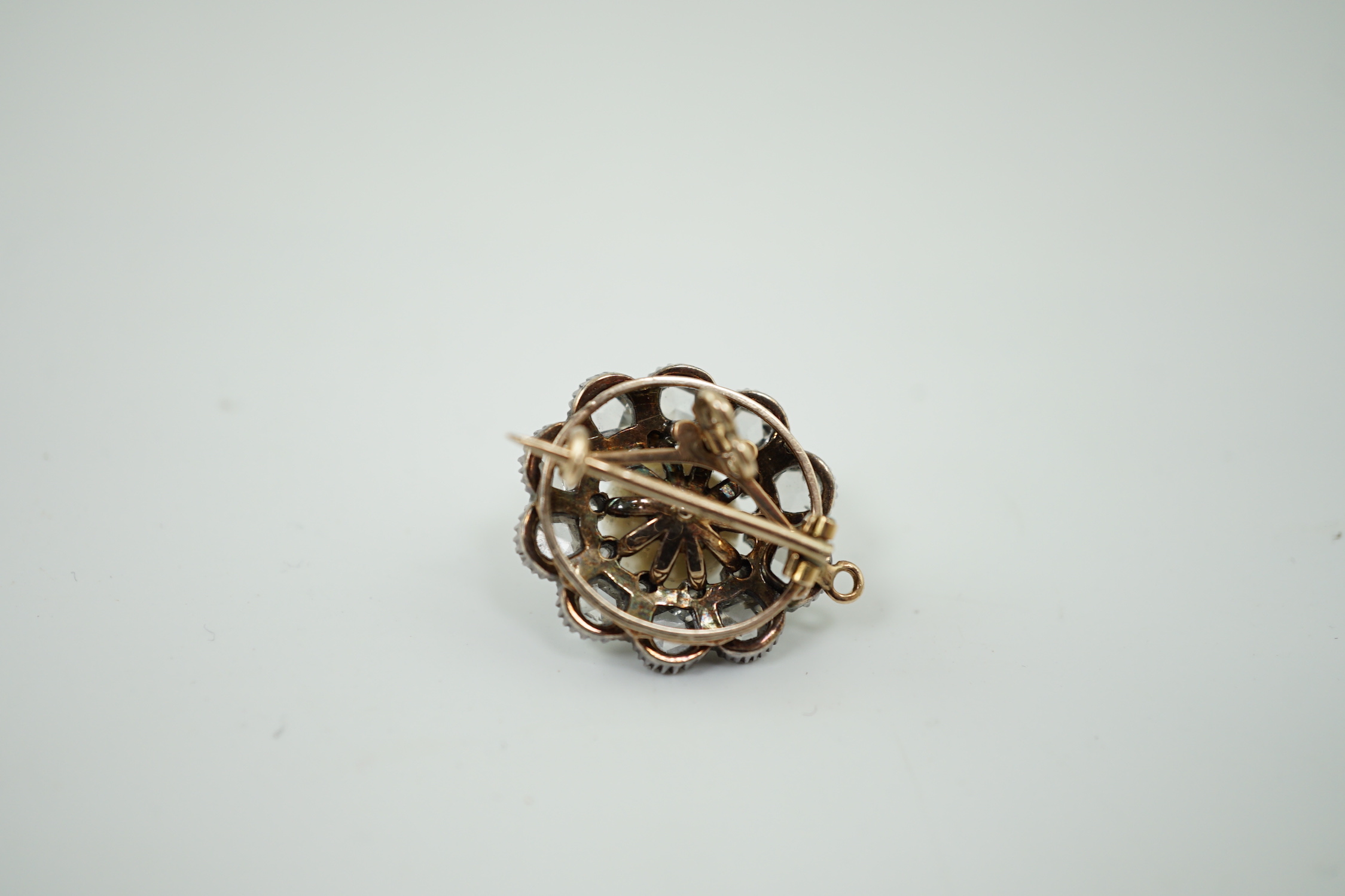A 19th century gold and silver, single stone natural saltwater part drilled button pearl and rose and round cut diamond cluster set pendant brooch